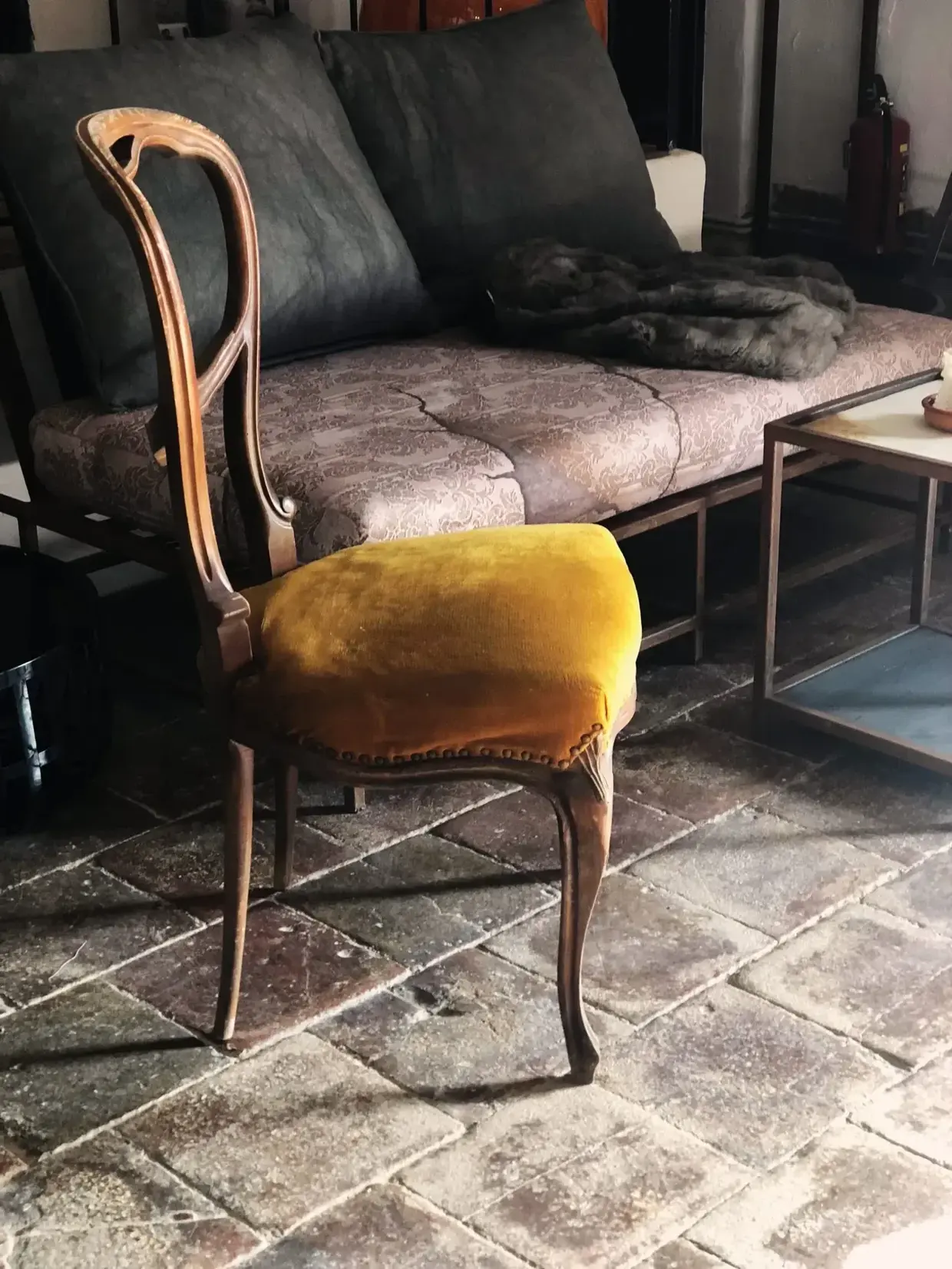 Vintage chair in front of new rustic metal furniture at Finca Legado