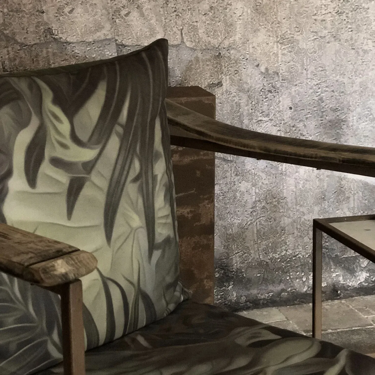 Rustic metall chair with plant patterned cushions